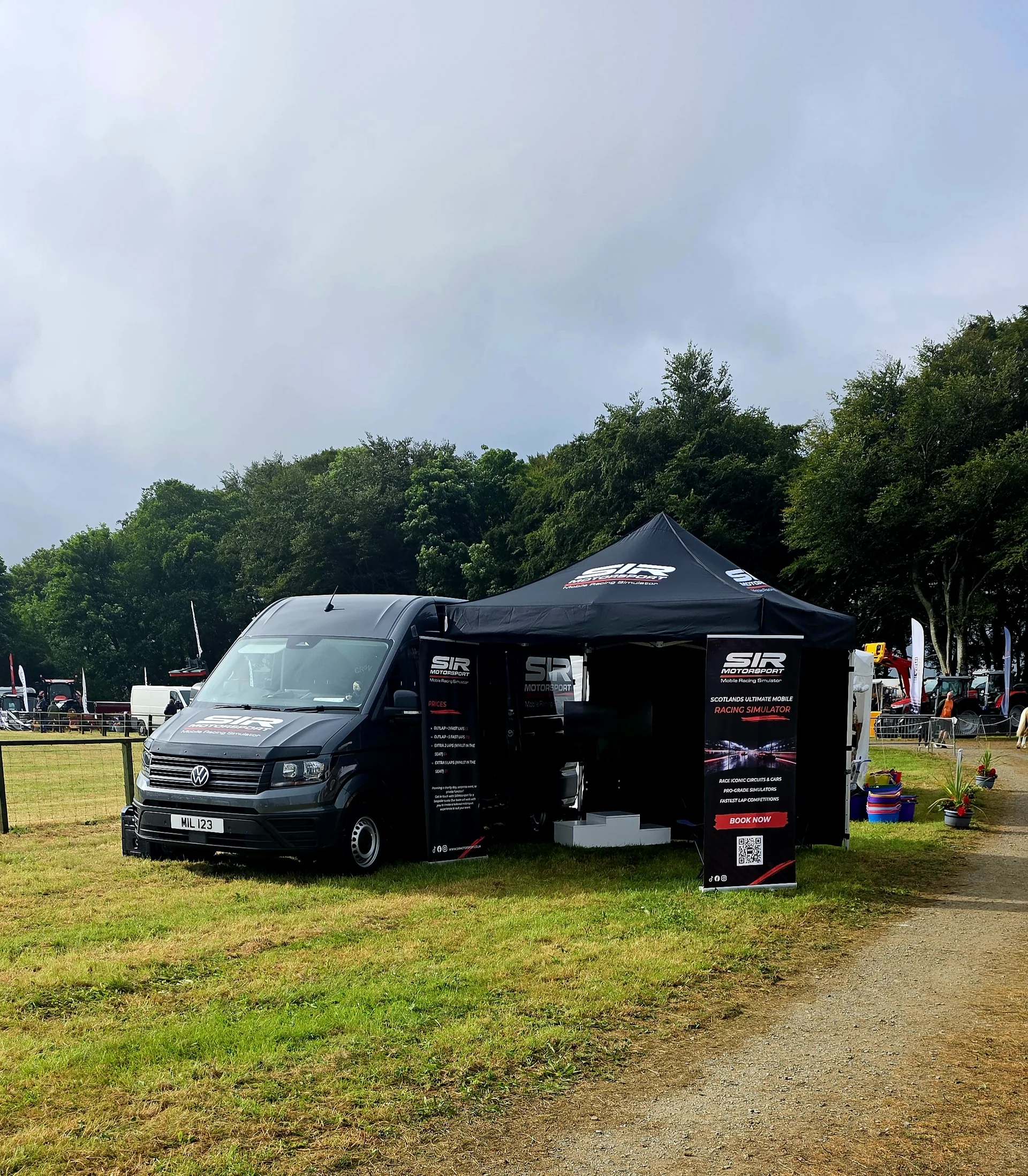 SIR Motorsport branded mobile simulator setup at an outdoor show