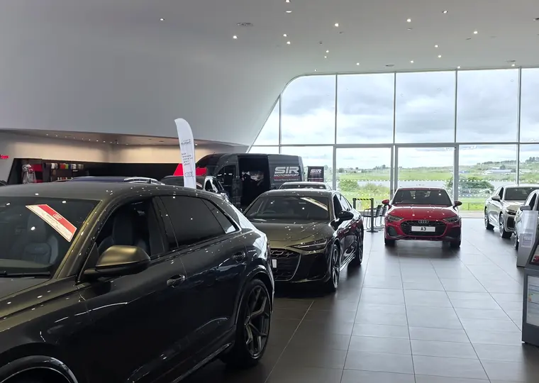 SIR Motorsport activation inside a premium car showroom event venue.